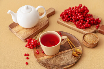 Healthy viburnum tea on color background