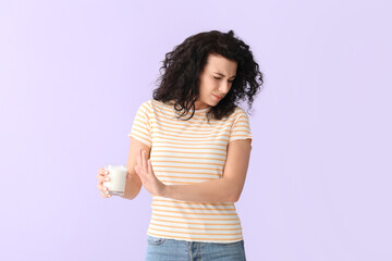 Young woman with dairy allergy on color background