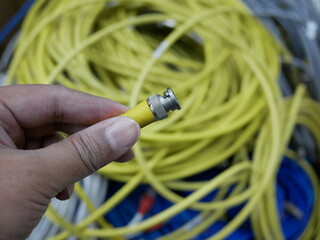 hand holding BNC SDI signal cables plugged connection in broadcast.