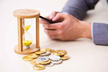 Young man earning money via Internet in time management concept