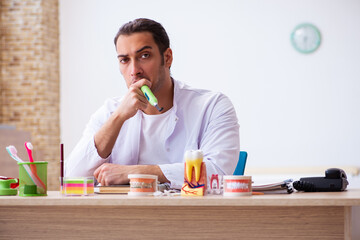 Fototapeta premium Young male dentist working in the clinic