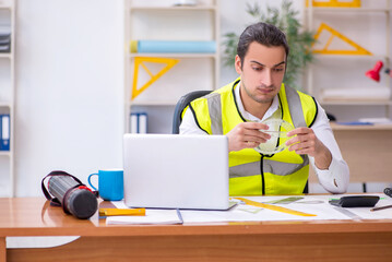 Young male architect working in the office