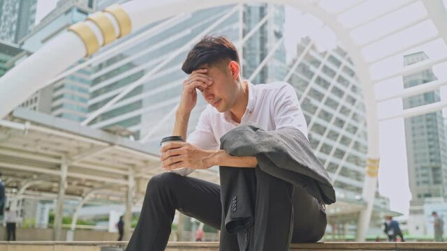 Asian businessman feeling bad after unemployment from his company.