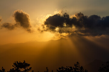 sun rays fall through the clouds