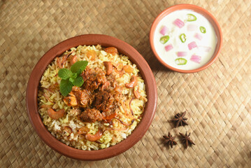 Mutton biryani , Gosht or lamb biryani or Hyderabadi Dum biriyani with raita yoghurt dip special occasion festival food  for Ramadan , Eid Hyderabad India.