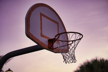 basketball hoop against sunrise sky