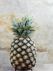 Pineapple with old wall.