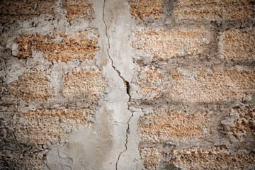 Rough texture of a brick wall made of shells. There is a crack in the middle of the wall.
