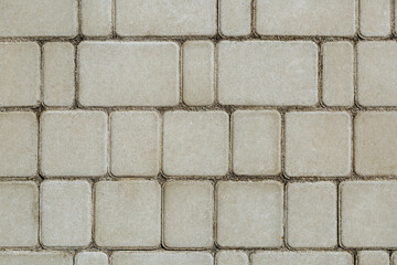 Concrete or cobble gray square pavement slabs or stones for floor, wall or path. Traditional fence, court, backyard or road paving. 