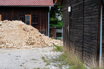 a gravel heap next to wooden huts