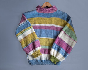 Hand-knitted striped women's oversized sweater made of multicolored wool