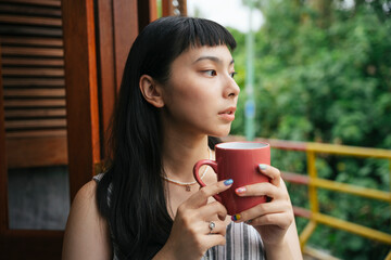 Asian woman drinking cup of coffee in the morning for breakfast.