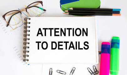 in the notepad text ATTENTION TO DETAILS, next to the highlighters for text, glasses, diagrams.