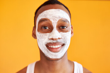 good-looking male enjoy skin care procedures, he has problems with skin, want soft skin on face, apply mask, look at camera