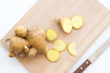 ginger slice herbal vegetarian local of asia  on block chopping and knife prepare to cook