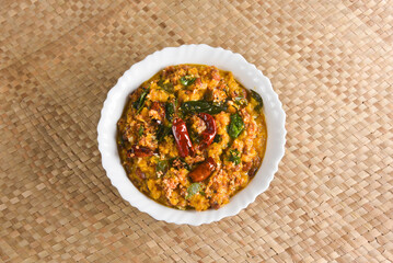 Kerala food for Onam festival special curry Erissery  , Pumpkin curry , Mathanga Elissery Onam sadya , sadhya palm mat background India. popular Sri Lankan food . South Indian spicy vegetable curry