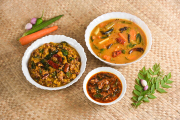 Kerala food for Onam festival special curry Sambar , Erissery , puli inji  Onam sadya , sadhya  palm mat background. popular Sri Lankan food . South Indian spicy vegetable curry vegan vegetarian dish