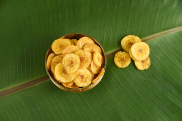 Kerala banana chips deep fried in coconut oil Kerala food for Onam festival special on Onam sadya , sadhya green banana leaf background India. popular Sri Lankan snack food South Indian tea time snack