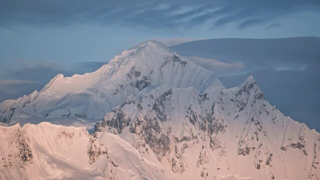 Timelapse of iceberg mountain top aerial. Nobody wild nature landscape of antarctic winter. Antarctica snow covered mouts ranges at cloudy polar day. Environment climate change concept