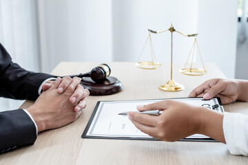 A male lawyer or a judge counseling clients about judicial justice and prosecution with scales,...