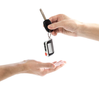 The hand passes the car keys to the other hand. Close up. Isolated on a white background