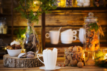 Christmas decoration cocoa bar with cookies and sweets on old wooden background in  natural rustic style. Winter cozy concept