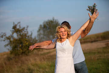 Beautiful middle-aged couple in love on the background of nature.