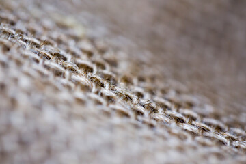 Macro bokeh shallow depth craft wool mat with woven pattern texture background retro