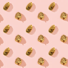 Natural pine cones golden colored as New Year pattern. Bright Christmas holidays decor