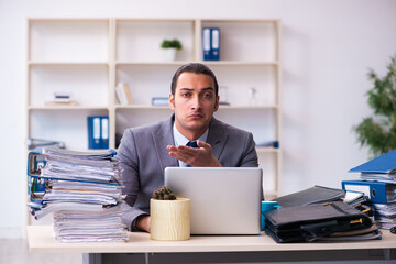 Young male employee unhappy with excessive work