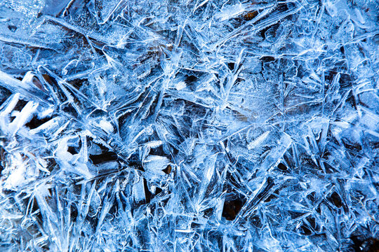 Patterns in ice of a frozen stream in the Swiss Alps