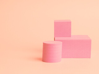Stack of pink blocks. Geometrical figures still life composition. Platonic solids figures, simplicity concept photography. Pink rectangles and cylinders