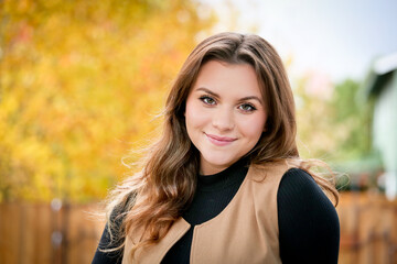 Close up Portrait of 18 Years Old Beautiful, Gorgeous Girl with Long Brown hair and Big eyes, Blurry Fall Background, Happy Teenager 