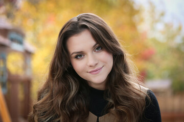 Fototapeta premium Close up Portrait of 18 Years Old Beautiful, Gorgeous Girl with Long Brown hair and Big eyes, Blurry Fall Background, Happy Teenager 