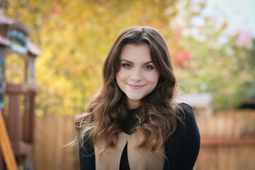 Close up Portrait of 18 Years Old Beautiful, Gorgeous Girl with Long Brown hair and Big eyes, Blurry Fall Background, Happy Teenager 