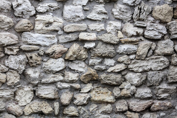 Stones in the wall of the house as an abstract background.