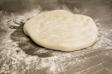 Fototapeta na wymiar prepare some bread dough on the counter for pizza