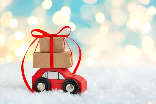 Christmas toy truck with gift boxes and pine tree on wooden table over green background - Powered by Adobe