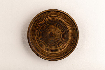 Top view on isolated brown wooden plate