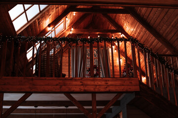 the second floor of a wooden house decorated for Christmas