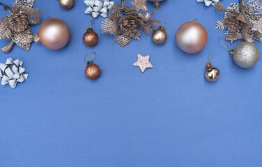 Beautiful christmas golden and silver deco baubles on blue background  with pine cone New year. Copy Space. Many beautiful deco baubles for Christmas tree. Box gift craft colour. Layout.