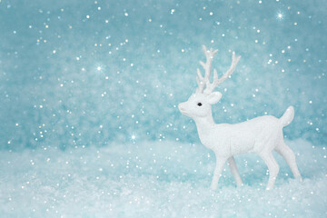 Christmas deer on a snowy background. New year card. Xmas concept with copy space.