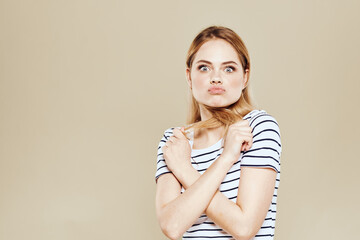 Fototapeta premium Cute blonde striped t-shirt smile lifestyle beige studio background