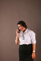 Happy oriental Asian young executive using mobile phone.