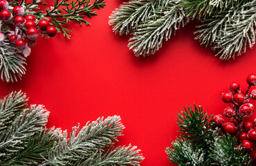 Fototapeta na wymiar Christmas red decorations, fir tree branches on red background