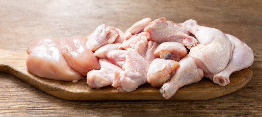 fresh chicken meat on a wooden board