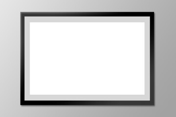 Black blank photo frame on a gray wall.
