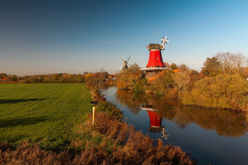 twin windmills on the river