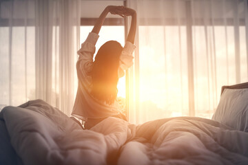 Woman stretching hands in bed after wake up in the morning, Concept of a new day and joyful weekend. - obrazy, fototapety, plakaty