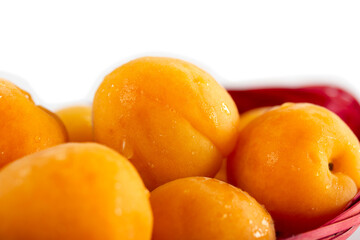 organic apricots in a pink basket